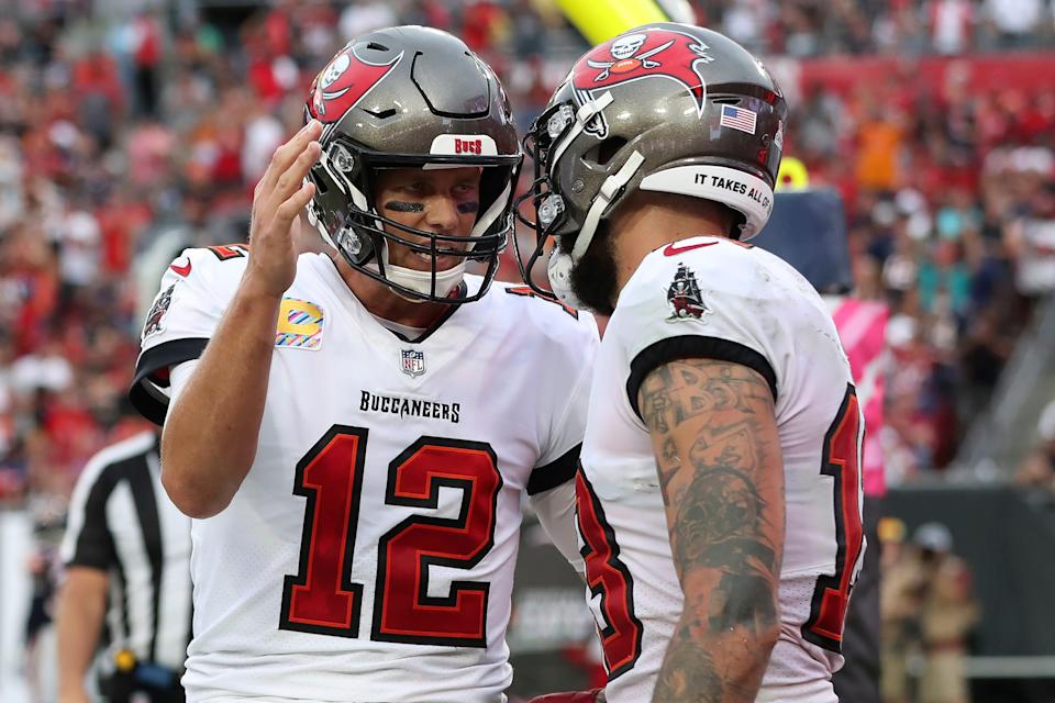 Tampa Bay Buccaneers quarterback Tom Brady (12) celebrates with wide receiver Mike Evans (13) after Evans couaght a touchdown pass during the first half of an NFL football game against the Chicago Bears Sunday, Oct. 24, 2021, in Tampa, Fla.