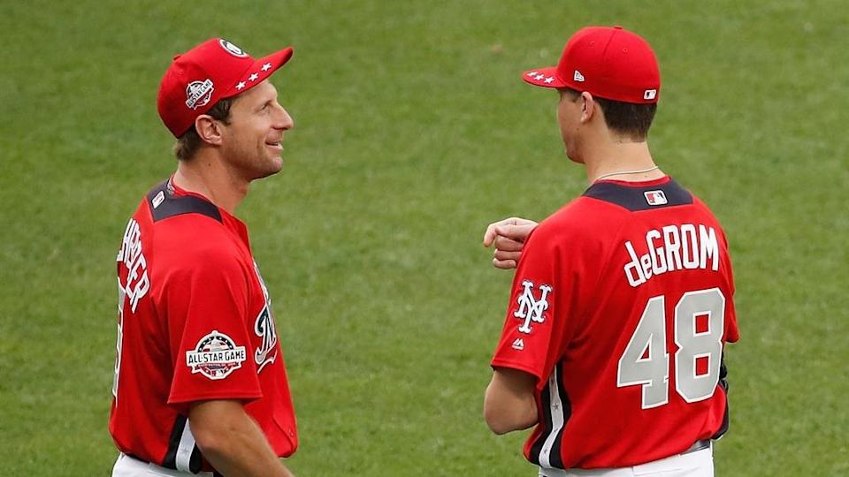 WASHINGTON, DC - JULY 16: Max Scherzer #31 of the Washington Nationals and the National League and Jacob deGrom #48 of the New York Mets and the National League stand in the outfield during Gatorade All-Star Workout Day at Nationals Park on July 16, 2018 in Washington, DC.