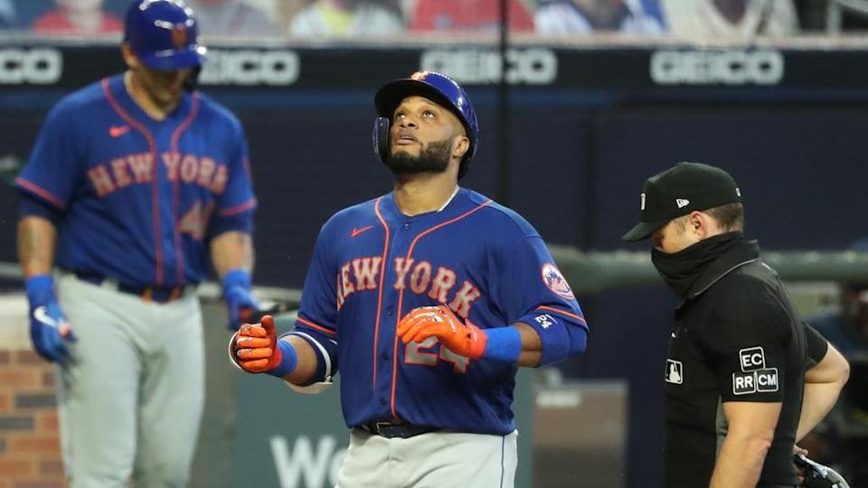 New York Mets second baseman Robinson Cano (24) reacts after his solo home run in the fifth inning against the Atlanta Braves at Truist Park.