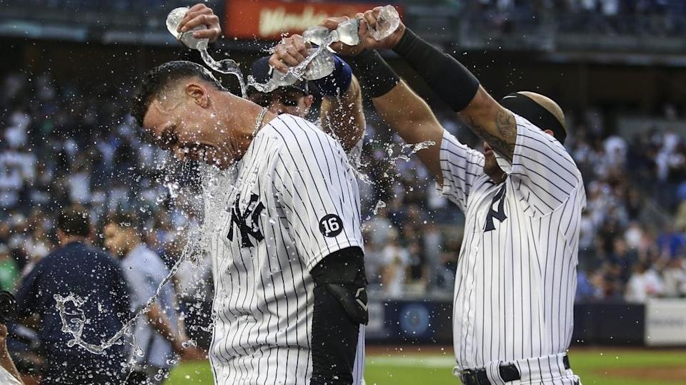 Oct 3, 2021; Bronx, New York, USA; New York Yankees right fielder Aaron Judge (99) is doused with water after his game winning RBI single to defeat the Tampa Bay Rays 1-0 and clinch a wildcard playoff spot at Yankee Stadium.