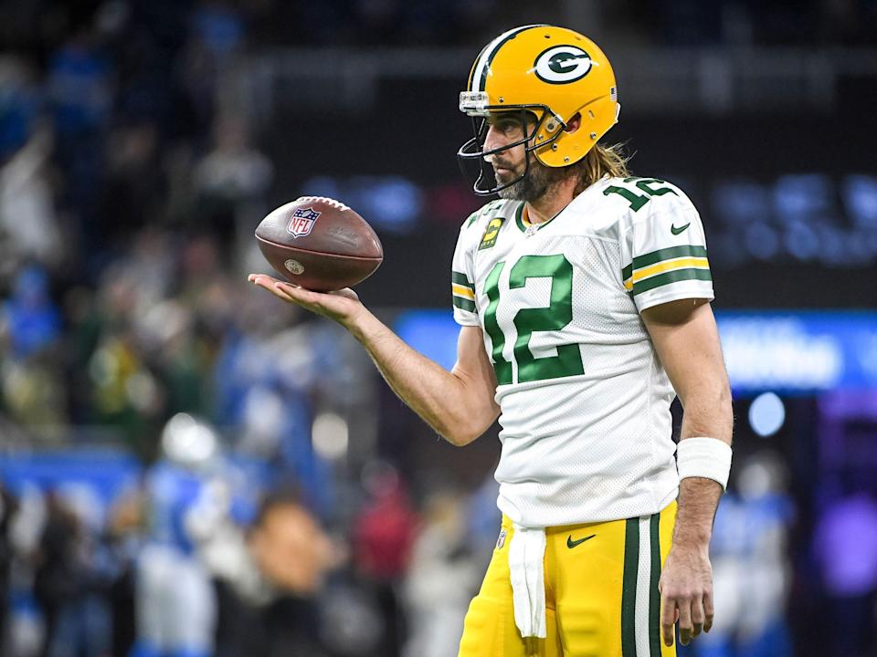 Aaron Rodgers warms up for a game against the Detroit Lions.