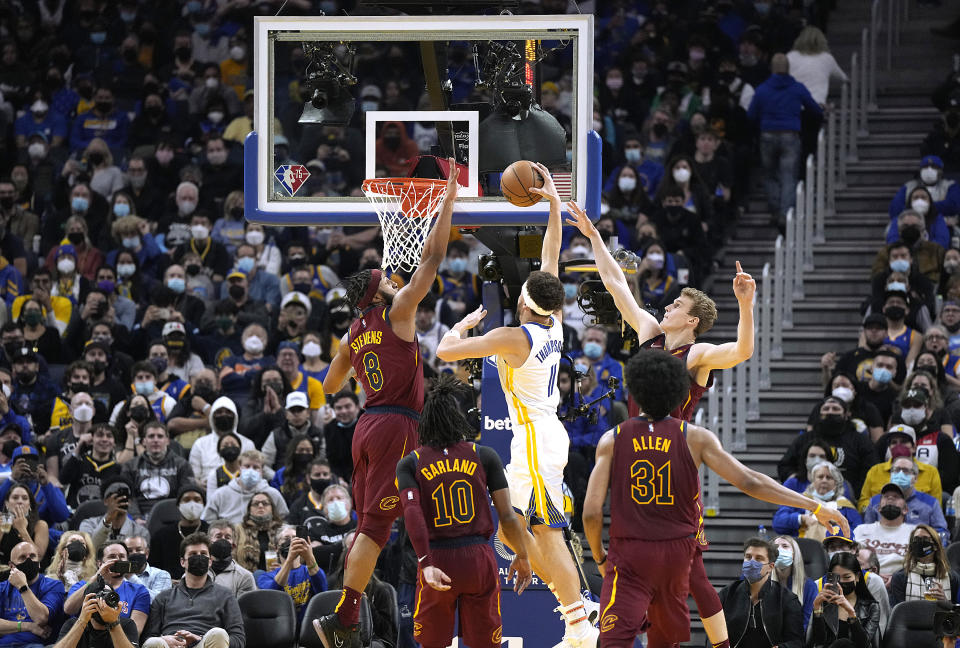 SAN FRANCISCO, CALIFORNIA - JANUARY 09: Klay Thompson #11 of the Golden State Warriors slam dunks over Lamar Stevens #8 of the Cleveland Cavaliers during the second quarter at Chase Center on January 09, 2022 in San Francisco, California. NOTE TO USER: User expressly acknowledges and agrees that, by downloading and or using this photograph, User is consenting to the terms and conditions of the Getty Images License Agreement. (Photo by Thearon W. Henderson/Getty Images)