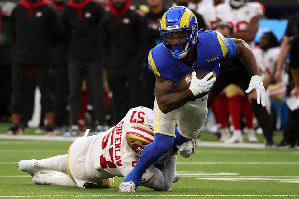 INGLEWOOD, CALIFORNIA - JANUARY 09: Cam Akers #23 of the Los Angeles Rams evades a tackle by Dre Greenlaw #57 of the San Francisco 49ers in the first quarter at SoFi Stadium on January 09, 2022 in Inglewood, California. (Photo by Harry How/Getty Images)