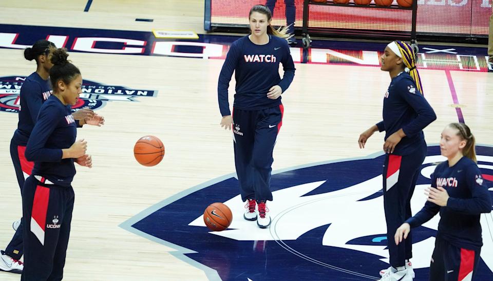 Connecticut guard Saylor Poffenbarger, center, warms up with teammates for an NCAA college basketball game against St. John's on Wednesday, Feb. 3, 2021, in Storrs, Conn. (David Butler II/Pool Photo via AP)