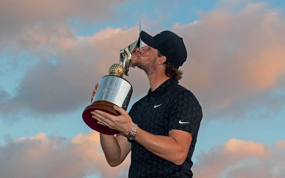 Thomas Pieters of Belgium poses with the trophy as he celebrates after winning the Final Round of the Abu Dhabi HSBC Championship at Yas Links Golf Course on January 23, 2022 - AFP