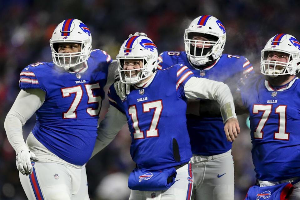 Josh Allen, second from left, celebrates with his offensive linemen.