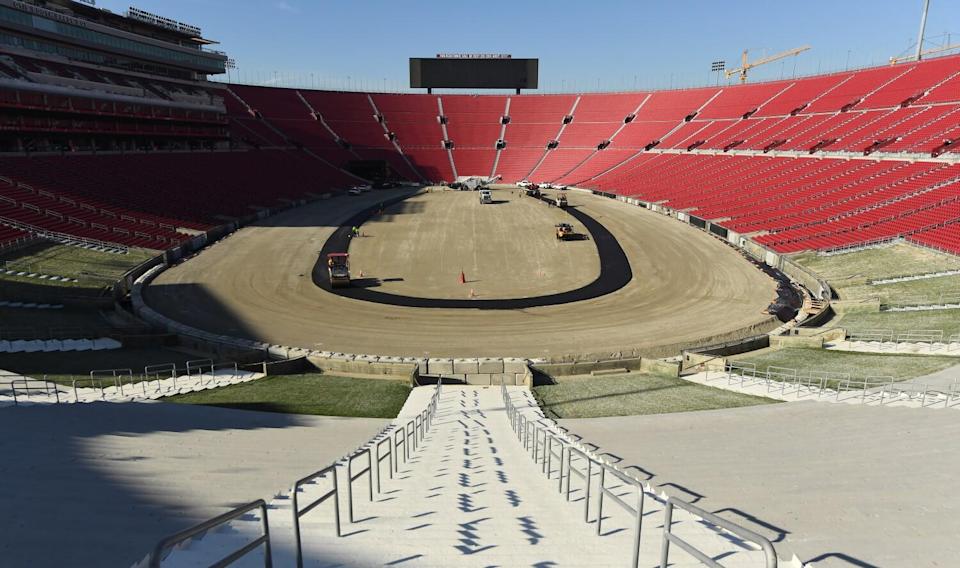 Work crews begin paving the track at the Coliseum in preparation for a NASCAR race