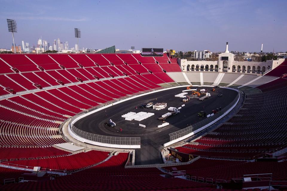 Construction crews transform the Coliseum from a football stadium to a quarter-mile short track NASCAR exhibition race track.