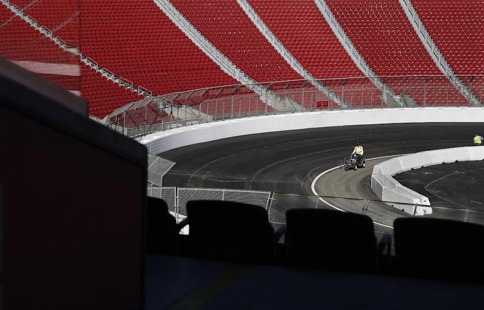 Lane lines are painted ahead of the NASCAR race at the Coliseum.