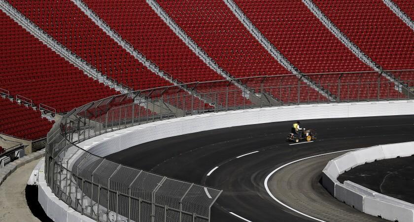 LOS ANGELES-CA-JANUARY 24, 2022: Lane lines are painted ahead of the NASCAR race at the L.A. Memorial Coliseum on Monday, January 24, 2022. (Christina House / Los Angeles Times)