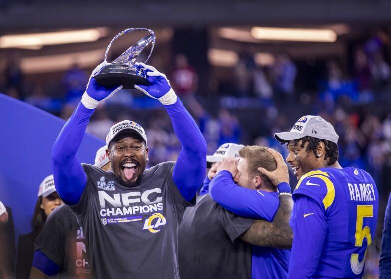 Rams linebacker Von Miller hoists the NFC championship trophy