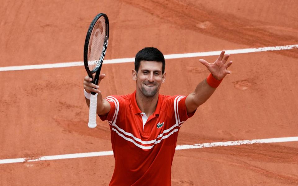 Serbia's Novak Djokovic celebrates towards the crowd after defeating Lithuania's Ricardas Berankis during their third round match on day 7, of the French Open tennis tournament at Roland Garros - AP Photo/Thibault Camus