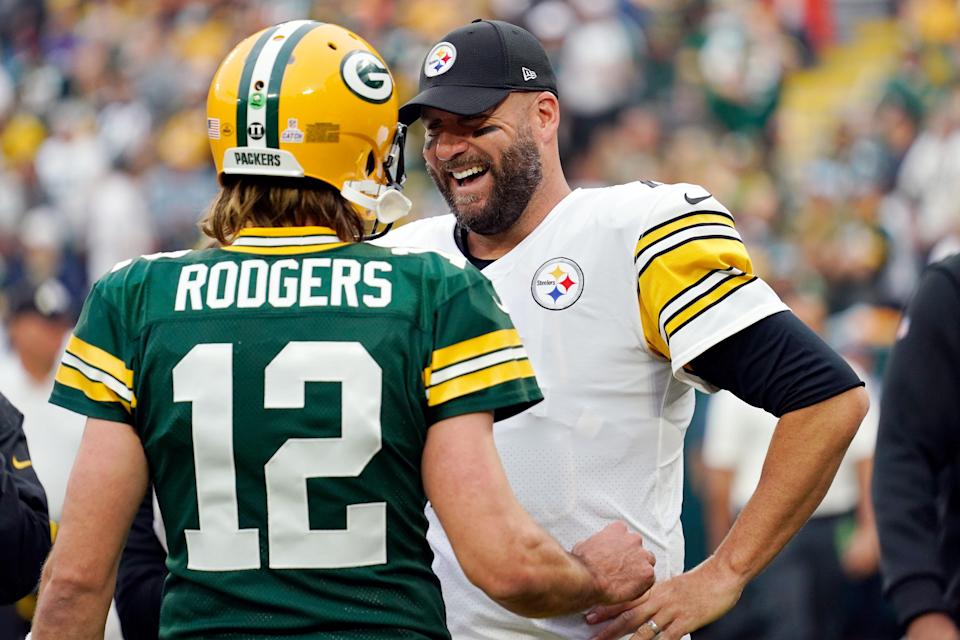 Aaron Rodgers #12 of the Green Bay Packers talks with Ben Roethlisberger #7 of the Pittsburgh Steelers before the game at Lambeau Field on October 03, 2021 in Green Bay, Wisconsin.