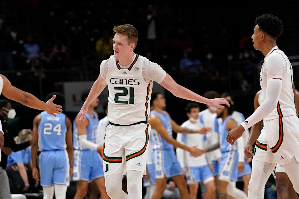 Miami forward Sam Waardenburg is congratulated by teammates during a break in Tuesday night’s game against North Carolina. Waardenburg scored 17 of his career-high 21 points in the first half.