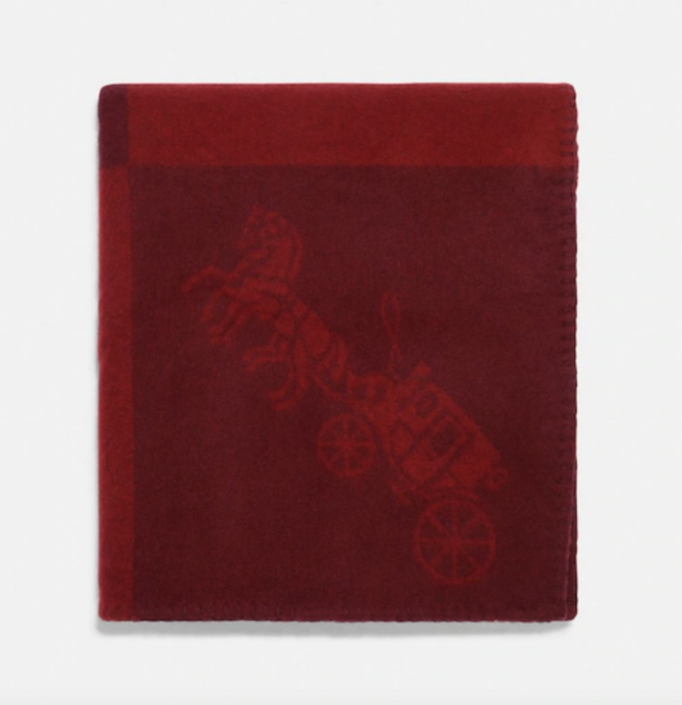 Horse And Carriage Print Blanket Scarf in red (Photo via Coach Outlet)