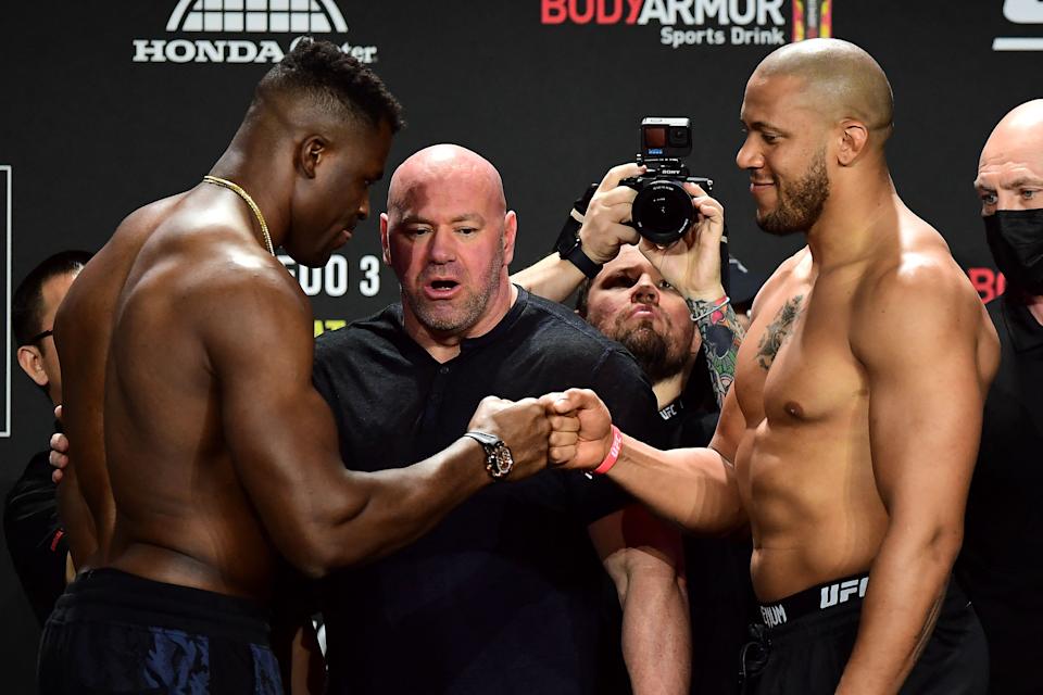 TOPSHOT - UFC 270 heavyweight world champion Cameroon's Francis Ngannou (L) and France's Ciryl Gane (R) bump fists as they weigh-in at the Anaheim Convention Center in Anaheim, California on January 21, 2022. (Photo by FREDERIC J. BROWN / AFP) (Photo by FREDERIC J. BROWN/AFP via Getty Images)