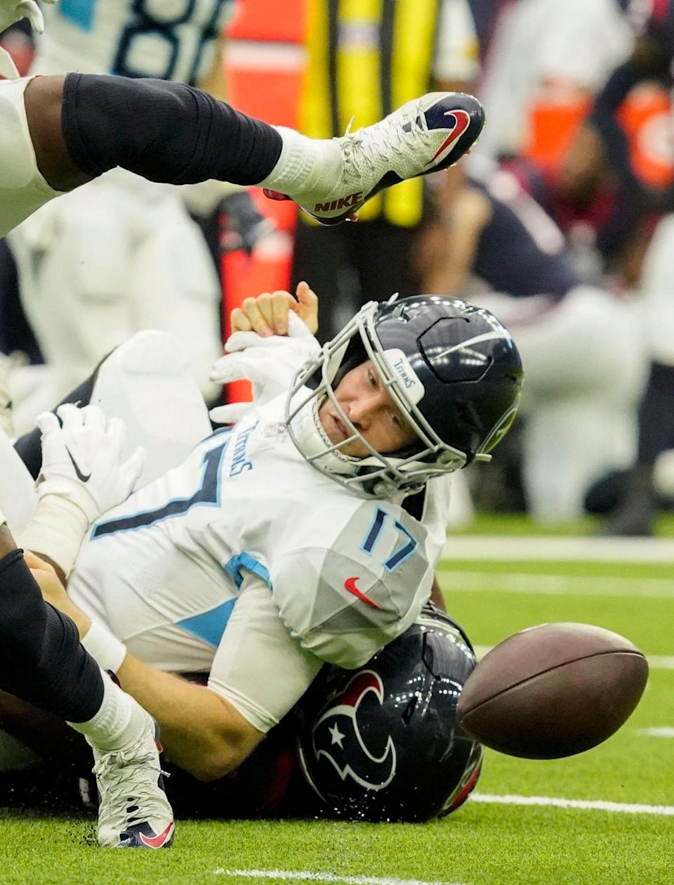 Tennessee Titans quarterback Ryan Tannehill (17) fumbles the ball as he is hit by Houston Texans defensive end Jordan Jenkins (50) during the third quarter at NRG Stadium Sunday, Jan. 9, 2022 in Houston, Texas.