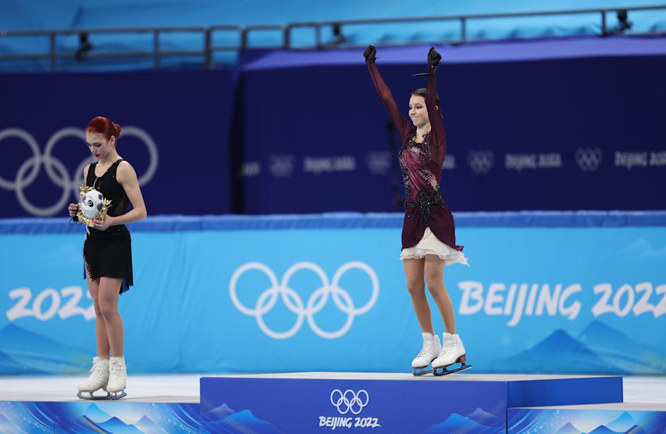 BEIJING, CHINA - FEBRUARY 17: Gold medallist Anna Shcherbakova of Team ROC (R), Silver Medallist Alexandra Trusova of Team ROC (L) celebrate during the Women Single Skating Free Skating flower ceremony on day thirteen of the Beijing 2022 Winter Olympic Games at Capital Indoor Stadium on February 17, 2022 in Beijing, China. (Photo by Matthew Stockman/Getty Images)