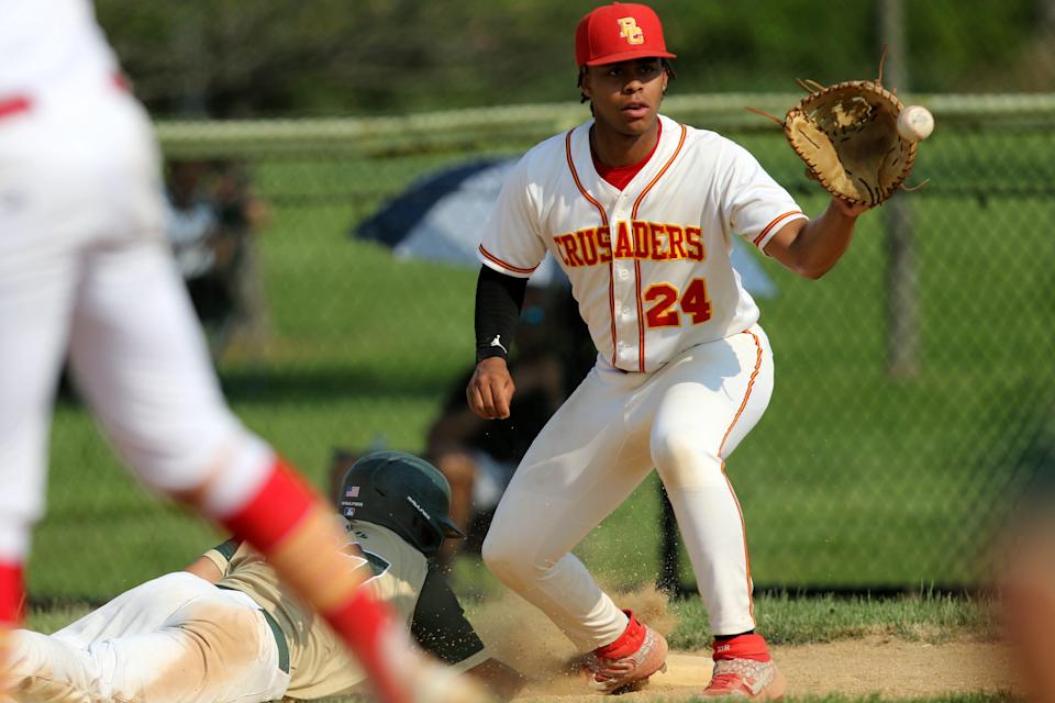 Bergen Catholic's Carsten Sabathia takes the throw at first base as Ellis Garcia of St. Joseph dives back to the bag in a Big North United Division baseball game. Wednesday, May 19, 2021.