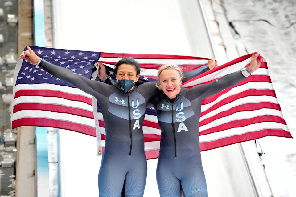 Gold medalist Kaillie Humphries, right, and silver medalist Elana Meyers Taylor, left, celebrate after Team USA goes 1-2 in the debut of women's monobob at the 2022 Beijing Olympics.