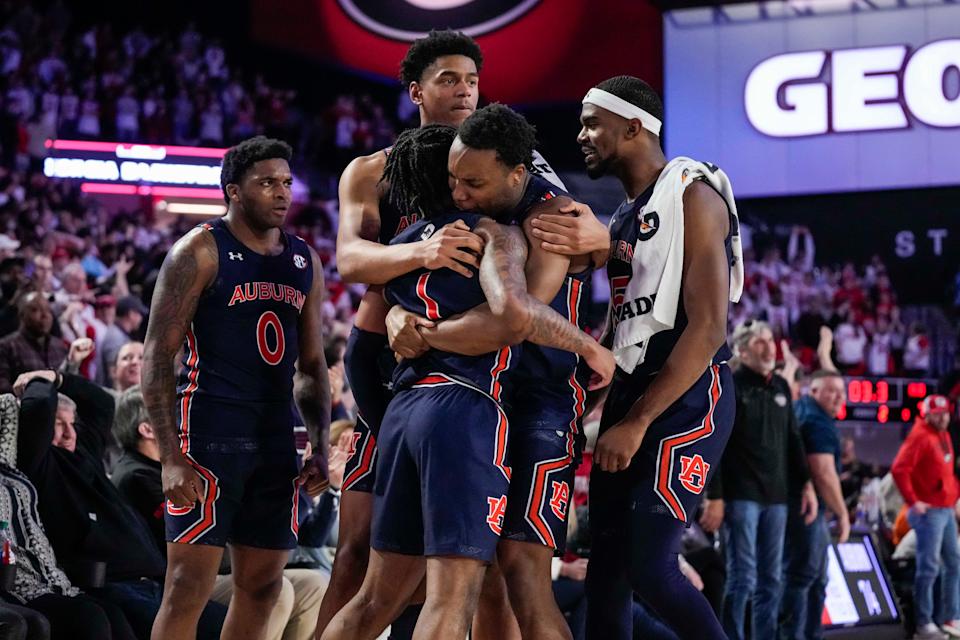 Auburn players celebrate with guard Wendell Green Jr. (1) after his game-winning basket against Georgia.