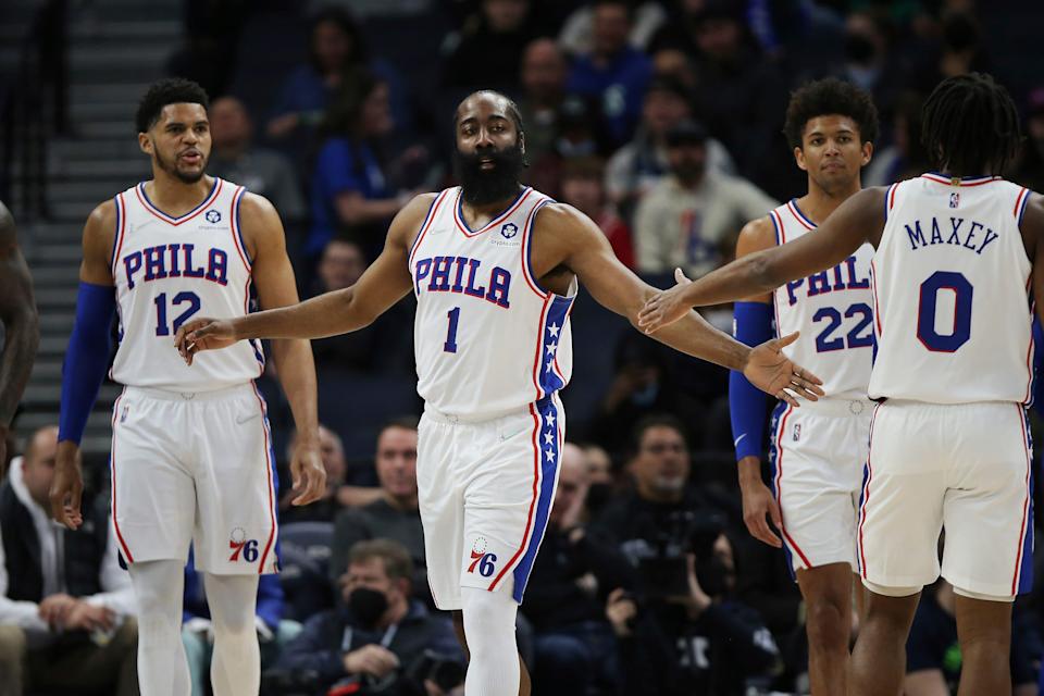 The Sixers' James Harden, 1, slaps hands with teammate Tyrese Maxey during Friday night's game against the Timberwolves.