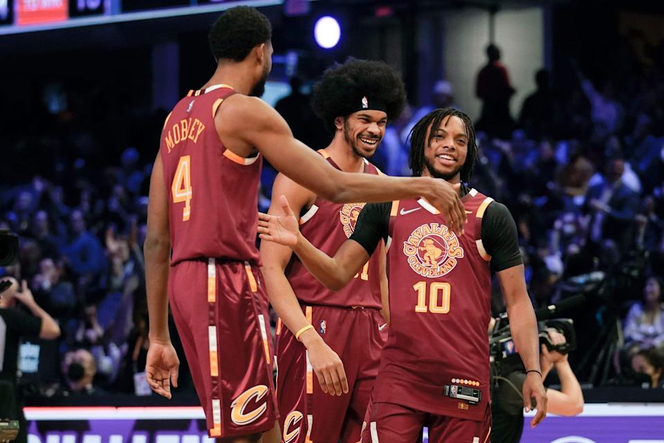 Darius Garland (10) celebrates with Cavaliers teammates Evan Mobley (4) and Jarrett Allen after winning the team shooting part during the Skills Challenge, part of NBA All-Star Weekend, Saturday, Feb. 19, 2022, in Cleveland. The Cavs trio won the overall Skills Challenge.