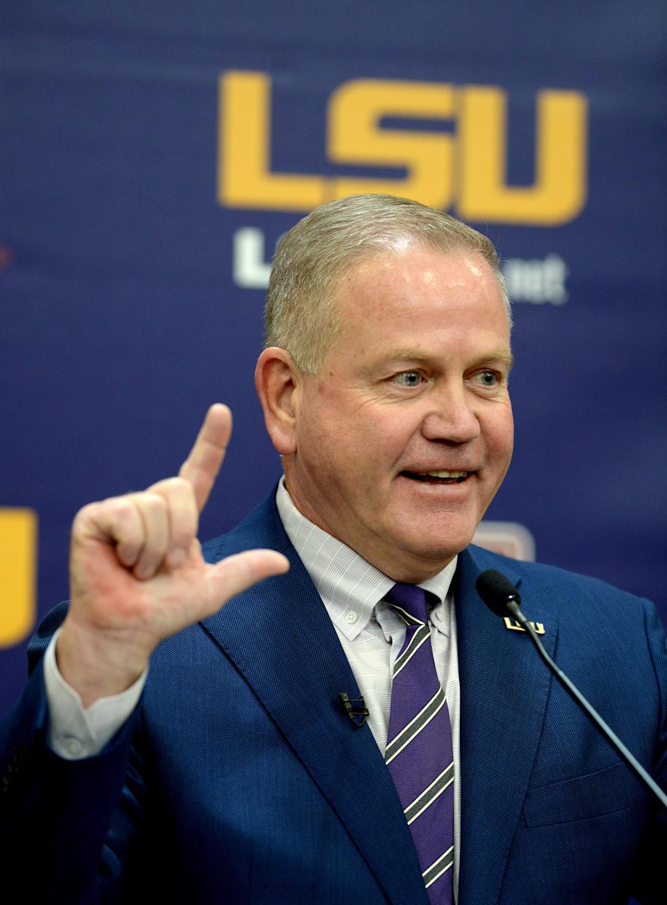 Dec 1, 2021; Baton Rouge, LA, USA; Newly named LSU Tigers head football coach Brian Kelly gives the ÒLÓ sign for LSU as he answers media questions after being introduced in a press conference at Tiger Stadium. Mandatory Credit: Patrick Dennis-USA TODAY Sports