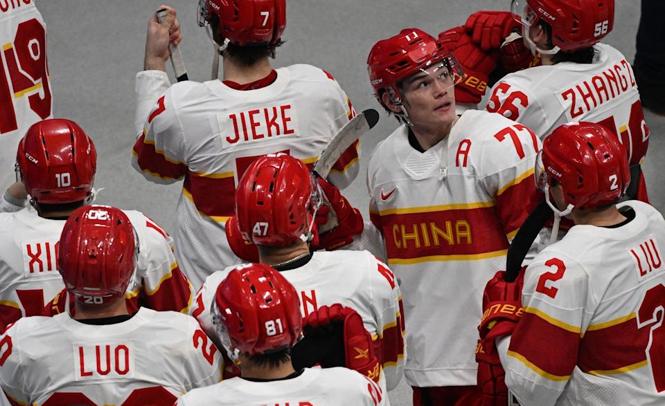 China's Ty Schultz looks up as the team leaves the rink after losing 8-0 to USA in their men's preliminary round group A match at the Beijing 2022 Winter Olympic Games. ( ANTHONY WALLACE/AFP via Getty Images)