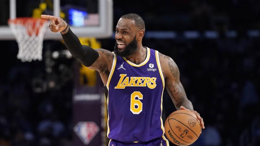 Los Angeles Lakers forward LeBron James gestures during the second half of an NBA basketball game.