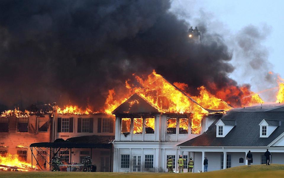 A fire burns at the main building at Oakland Hills Country Club - AP