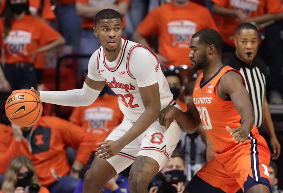 Ohio State forward E.J. Liddell controls the ball while defended by Illinois guard Da'Monte Williams during the first half at State Farm Center.