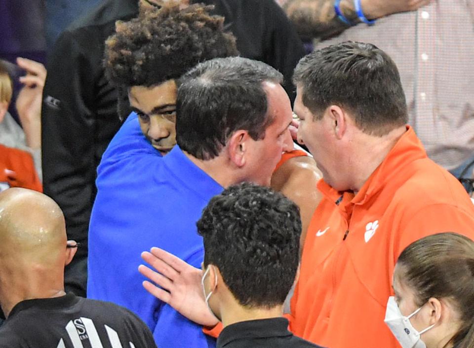 Duke coach Mike Kryzewski hugs David Collins after the Clemson player was ejected from Thursday night's game.