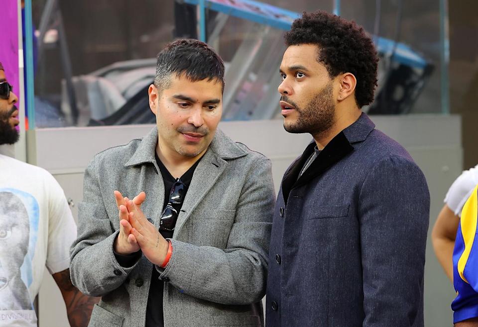 Two men standing at a football game.