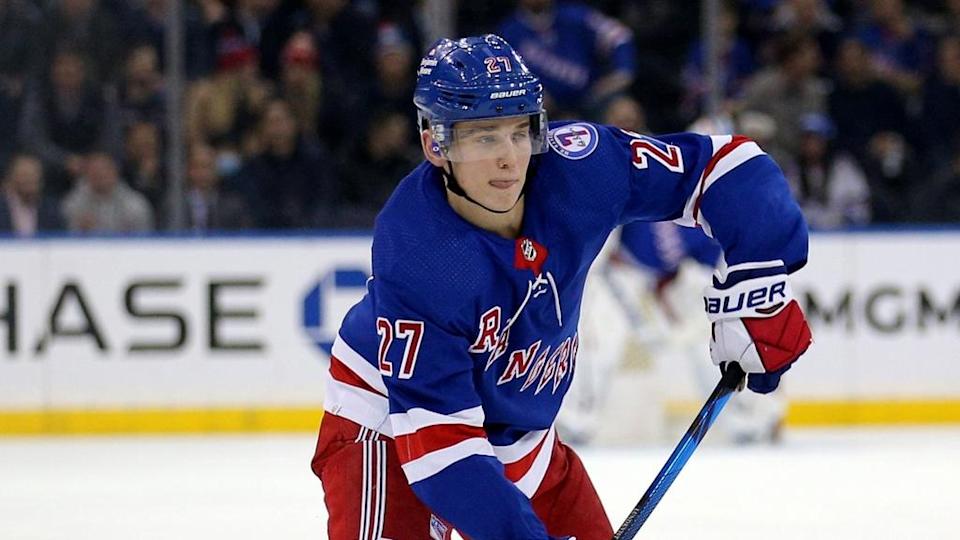 Nils Lundkvist handling puck with Rangers in blue jersey 2021