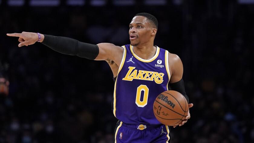 Los Angeles Lakers guard Russell Westbrook dribbles during the first half of an NBA basketball game.