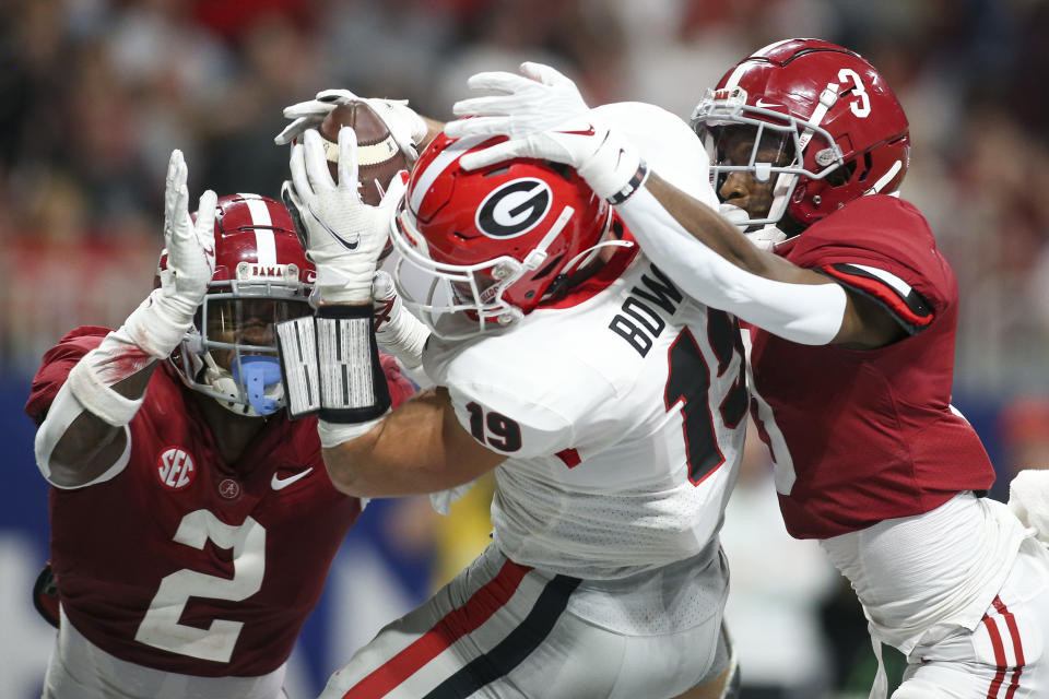 Dec 4, 2021; Atlanta, GA, USA; Georgia Bulldogs tight end Brock Bowers (19) has a reception broken up by Alabama Crimson Tide defensive back DeMarcco Hellams (2) and defensive back Daniel Wright (3) in the second half during the SEC championship game at Mercedes-Benz Stadium. Mandatory Credit: Brett Davis-USA TODAY Sports