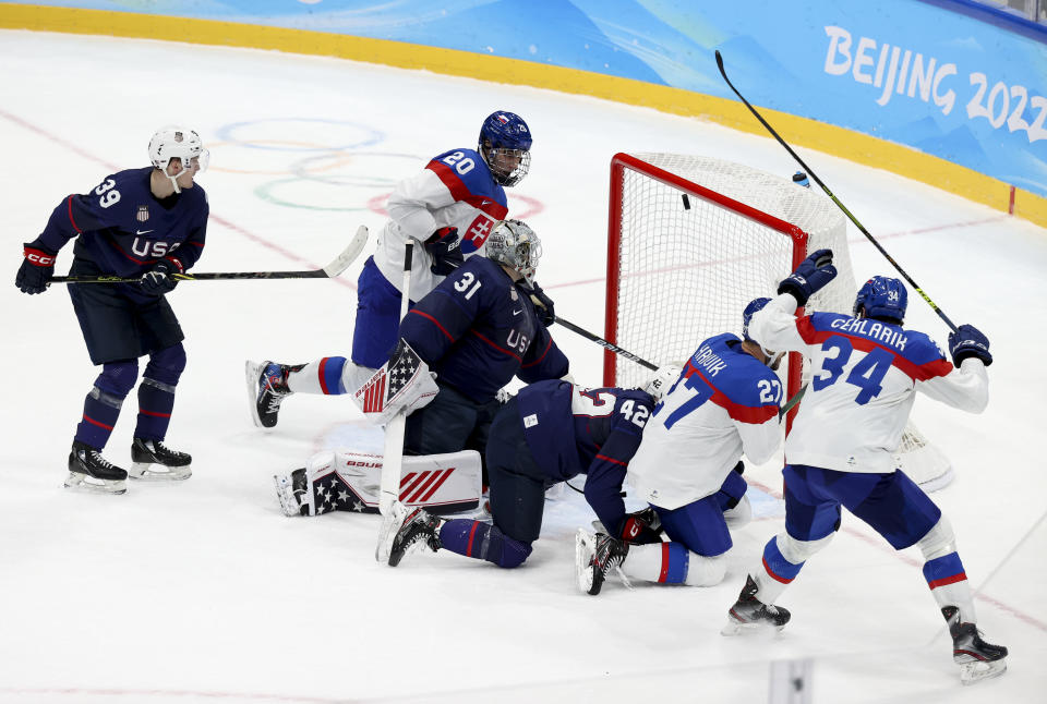 BEIJING, CHINA - FEBRUARY 16: Marek Hrivik of Slovakia #27 scores against goalkeeper Strauss Mann of USA the tying goal at 2-2 at the last minute sending Slovakia to overtime during the Men