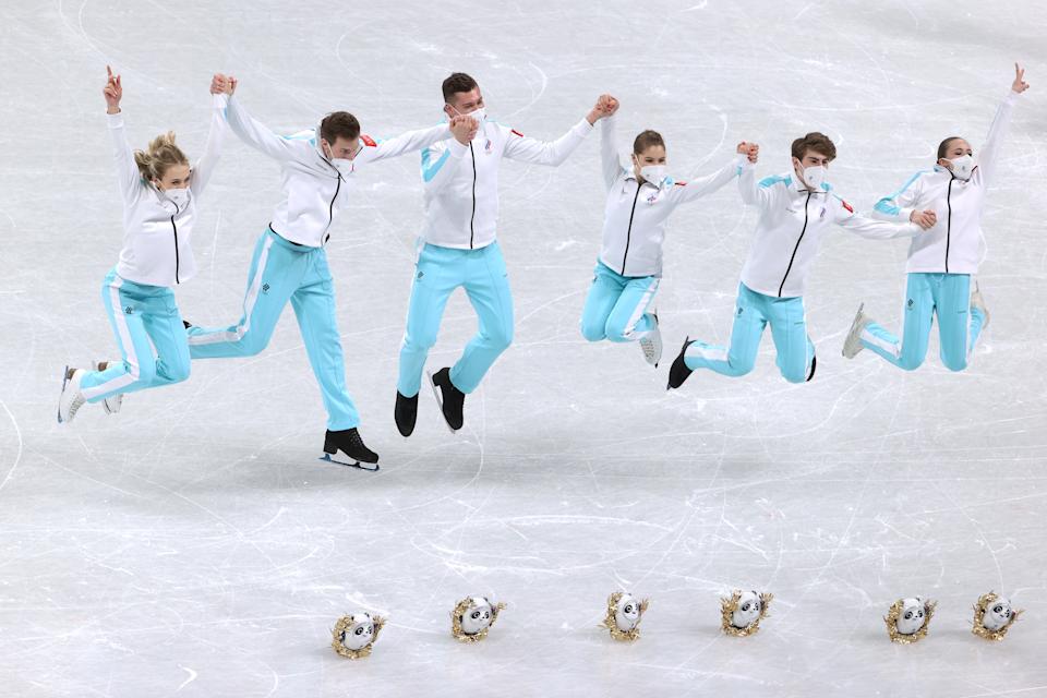 BEIJING, CHINA - FEBRUARY 07: Gold medalists Kamila Valieva, Anastasia Mishina, Aleksandr Galliamov, Victoria Sanitsina, Nikita Katsalapov, Mark Kondratiuk of Team Russia celebrate during the Team Event flower ceremony on day three of the Beijing 2022 Winter Olympic Games at Capital Indoor Stadium on February 07, 2022 in Beijing, China. (Photo by Jean Catuffe/Getty Images)