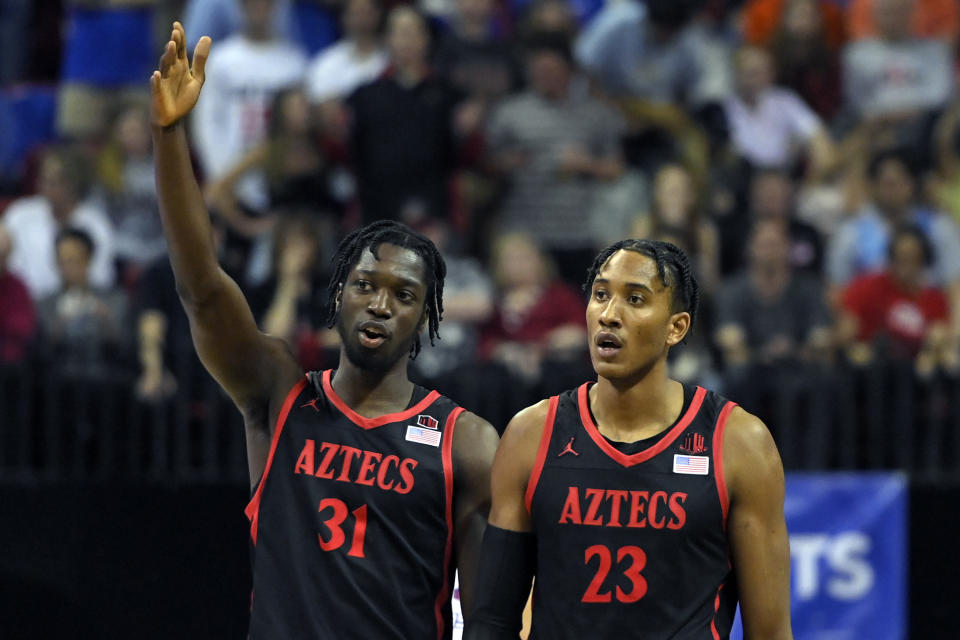 LAS VEGAS, NEVADA - MARCH 12: Nathan Mensah #31 and Joshua Tomaic #23 of the San Diego State Aztecs talk duirng a break in the action during the championship game of the Mountain West Conference basketball tournament against the Boise State Broncos at the Thomas & Mack Center on March 12, 2022 in Las Vegas, Nevada. (Photo by David Becker/Getty Images)