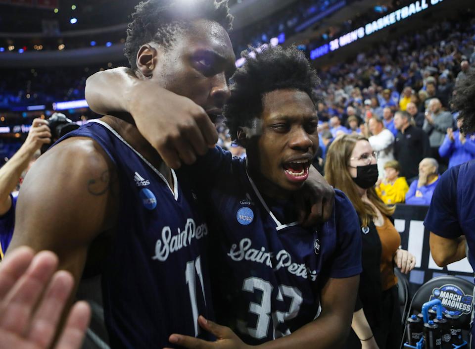 Saint Peter's KC Ndefo (left) and Jaylen Murray leave the court after the Peacocks' 67-64 win against Purdue to advance to the Elite Eight in the NCAA tournament at the Wells Fargo Center in Philadelphia, March 25, 2022.