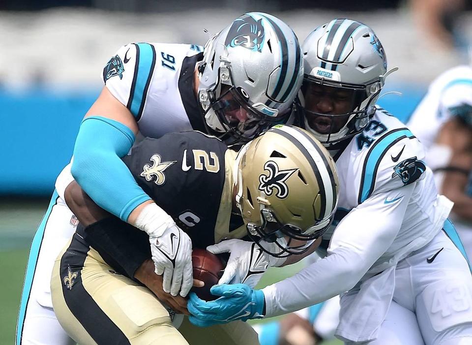 Carolina Panthers defensive end Morgan Fox, left and linebacker Haason Reddick, right, sack New Orleans Saints quarterback Jameis Winston during second quarter action at Bank of America Stadium in Charlotte, NC on Sunday, September 18, 2021.