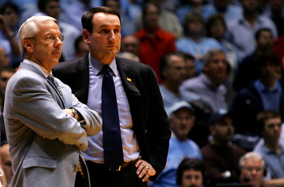 CHAPEL HILL, NC - MARCH 04: Head coach Mike Krzyzewski (R) of the Duke Blue Devils waits on the officials with head coach Roy Williams of the University of North Carolina Tar Heels after an incident involving Tyler Hansbrough and Gerald Henderson during their game at the Dean E. Smith Center on March 4, 2007 in Chapel Hill, North Carolina. North Carolina defeated Duke, 86 - 72. (Photo by Streeter Lecka/Getty Images)