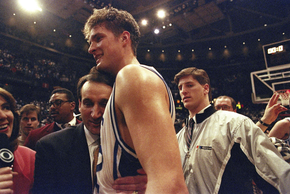 FILE - In this March 28, 1992, file photo, Duke University basketball head coach Mike Krzyzewski hugs his star center Christian Laettner after Duke defeated Kentucky in overtime 104-103 to win NCAA East Regional Final in Philadelphia. (AP Photo/Amy Sancetta, File)