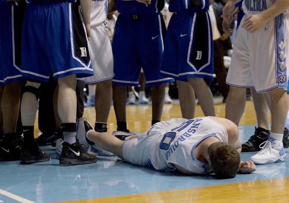 North Carolina's Tyler Hansbrough lies face down on the Smith Center court late in the second half after being struck in the face by Duke's Gerald Henderson (15) at the Smith Center in Chapel Hill, North Carolina, Sunday, March 4, 2007. The Tar Heels defeated the Blue Devils 86-72. (Photo by Ted Richardson/Raleigh News & Observer/Tribune News Service via Getty Images)