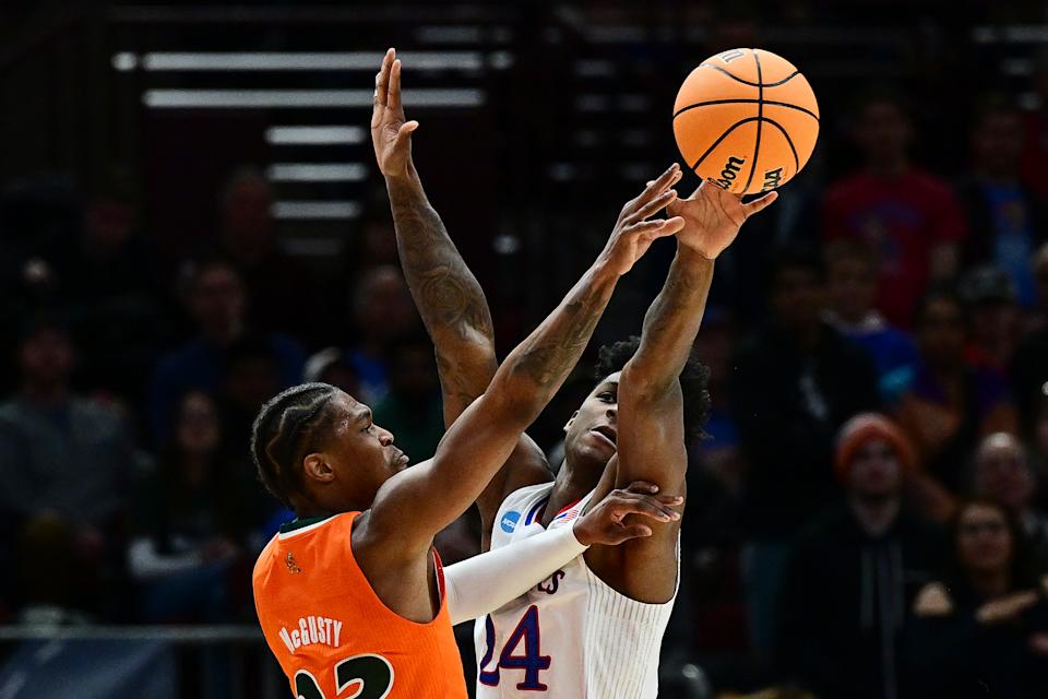 CHICAGO, ILLINOIS - MARCH 27: Kameron McGusty #23 of the Miami Hurricanes competes for the ball against K.J. Adams #24 of the Kansas Jayhawks during the first half in the Elite Eight round game of the 2022 NCAA Men's Basketball Tournament at United Center on March 27, 2022 in Chicago, Illinois. (Photo by Quinn Harris/Getty Images)