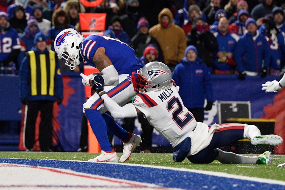 Buffalo Bills wide receiver Gabriel Davis (13) hauls in a pass from Josh Allen for a touchdown with New England Patriots cornerback Jalen Mills (2) defending during the first half of an NFL football game in Orchard Park, N.Y., Monday, Dec. 6, 2021. (AP Photo/Adrian Kraus)