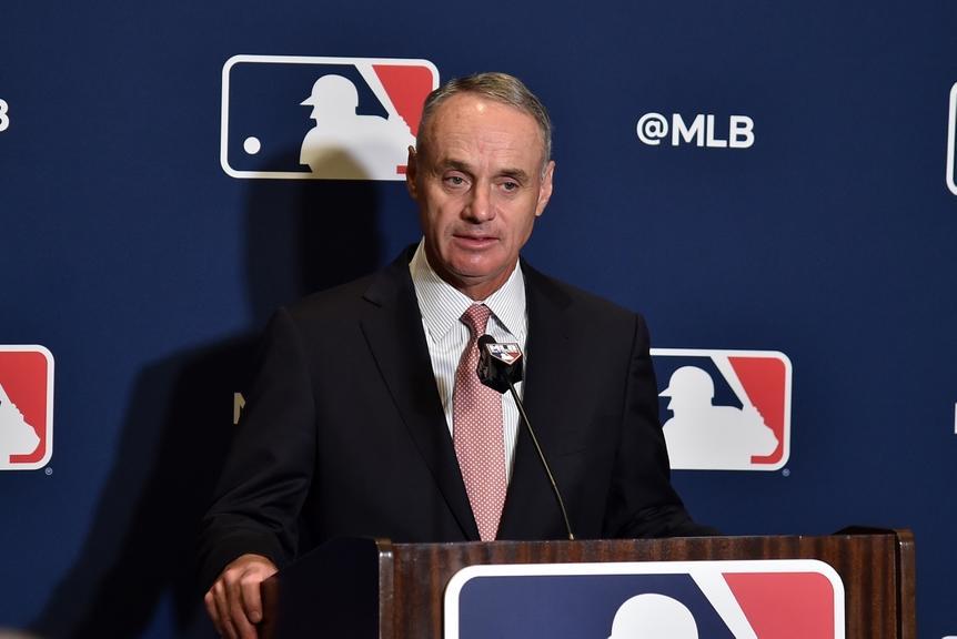 Rob Manfred at podium in front of MLB logo