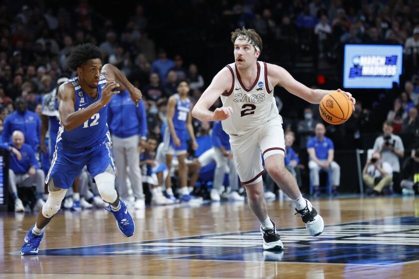 Gonzaga forward Drew Timme (2) drives past Memphis forward DeAndre Williams.