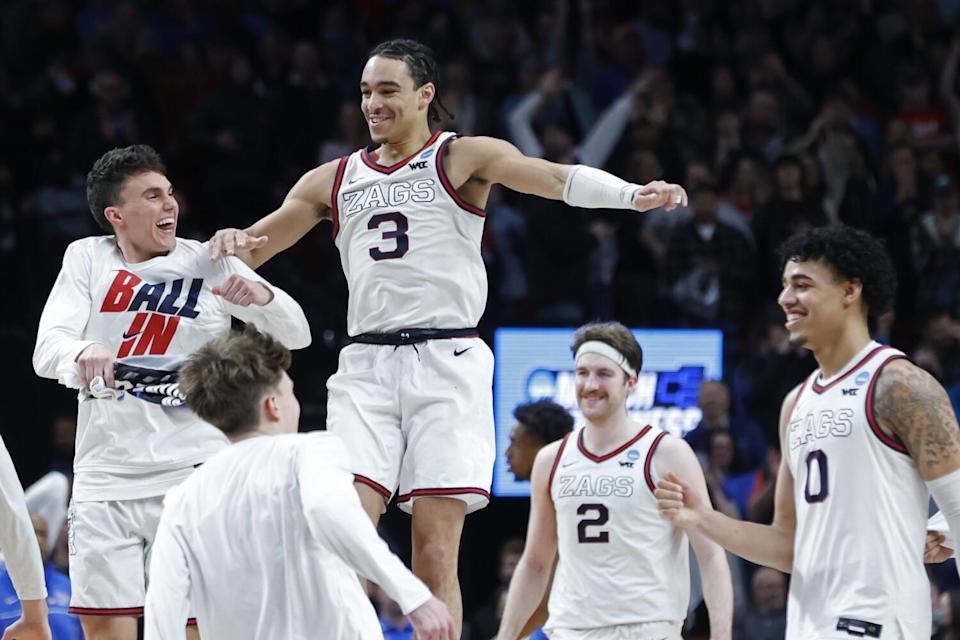 Gonzaga guard Andrew Nembhard (3) and forward Drew Timme (2) celebrate with teammates.